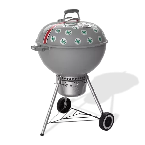 Ohio State-themed charcoal grill with Buckeye leaf stickers and a red stripe on the lid, featuring a classic kettle design with wheels and a vented ash catcher.